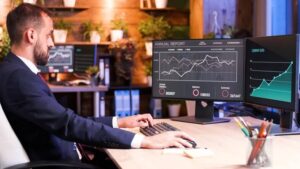 Man Working at Office with Two Monitors